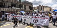 Operation Dudula members make their way down the streets of Hillbrow during their protest on 19 February 2022. (Photo: Shiraaz Mohamed)