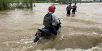 A man drives a motorbike through the flood in Bago, Myanmar, 09 October 2023. Storms and monsoon rains have caused floods and landslides in Myanmar.  EPA-EFE/NYEIN CHAN NAING