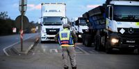 Traffic officer monitors trucks lined up to cross South Africas border into Mozambique at Lebombo Border control in Komatipoort, on July 14. Photographer: Leon Sadiki/Bloomberg