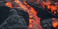 PAHOA, HI - MAY 12:  Lava flows at a lava fissure in the aftermath of eruptions from the Kilauea volcano on Hawaii's Big Island, on May 12, 2018 in Pahoa, Hawaii. The U.S. Geological Survey said a recent lowering of the lava lake at the volcano's Halemaumau crater Òhas raised the potential for explosive eruptionsÓ at the volcano. Authorities have confirmed the fissure is the 16th to open.  (Photo by Mario Tama/Getty Images)