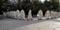 Shinto priests walk after attending a purification ritual during the annual autumn festival at the Yasukuni Shrine in Tokyo, Japan, 17 October 2024. Earlier in the day, the Japanese prime minister made a ‘masakaki’ offering at the start of the three-day autumn festival. Some 2.5 million Japanese soldiers who died while in military service are enshrined at Yasukuni.  EPA-EFE/FRANCK ROBICHON