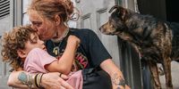 NEW ORLEANS, LOUISIANA - AUGUST 29: Ann Colette Boudreaux comforts her grandson Abel ahead of Hurricane Ida on August 29, 2021 in New Orleans, Louisiana. Residents of New Orleans continue to prepare as the outer bands of the hurricane begin to cut across the city. Ida is expected to make landfall as a Category 4 storm later today. (Photo by Brandon Bell/Getty Images)