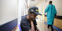 Johannesburg, South Africa - February 26, 2019: 23-year-old, Fuzile Jwara, holds his throat in pain after a gastrointestinal endoscopy at the Charlotte Maxeke Academic Hospital in Johannesburg, South Africa. Jwara has to be examined at least every six months because he's living with FAPS (Familial adenomatous polyposis), a genetic disorder that could become cancer. Picture: DANIEL BORN for DAILY MAVERICK