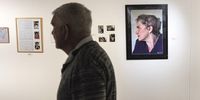 Journalist Andrew Forrest walks past a portrait of Gisèle Wulfsohn, after she started loosing her hair due to cancer. Wulfsohn was a freelance photographer specialising in portraiture, education, health and gender issues. Johannesburg, 9 November 2022.<br>Photo: Shiraaz Mohamed.