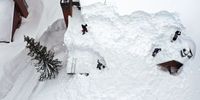 MAMMOTH LAKES, CALIFORNIA - MARCH 29: In an aerial view, workers remove snow from the roof of a condominium complex in the Sierra Nevada mountains, amid snow piled up from new and past storms, after yet another storm system brought heavy snowfall further raising the snowpack on March 29, 2023 in Mammoth Lakes, California. The Pacific storm delivered widespread rain and mountain snow to the U.S. west coast in Northern California and Oregon. After years of drought, the state snowpack average for California may hit an all time record from the several feet of new snow which fell during the storm in parts of the Sierra Nevada mountains. Nearby Mammoth Mountain ski resort announced today it has received the highest amount of total snow at the Main Lodge for any season, with 695 total inches, after at least 28 inches of new snow fell during the storm. (Photo by Mario Tama/Getty Images)