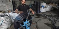 A Palestinian worker rolls an agricultural water hose made of plastic waste at a plastic recycling factory in the northern Gaza Strip, 01 June 2023. (Issued 03 June 2023) The World will mark the 2023 Environment Day on 05 June with a focus on "solutions to plastic pollution".  EPA-EFE/MOHAMMED SABER  ATTENTION: This Image is part of a PHOTO SET