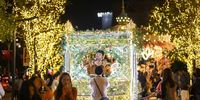 People pose for photographs under Christmas Lights decorations in Taipei, Taiwan, 18 December 2023. Christmas is not an official holiday in Taiwan, but many young Taiwanese celebrate it by having Christmas dinner or giving gifts to friends.  EPA-EFE/RITCHIE B. TONGO