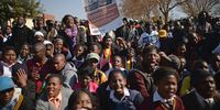 JOHANNESBURG, SOUTH AFRICA - JUNE 16:  Young people participate in a march to commemorate Youth Day in Soweto Township on June 16, 2013 in Johannesburg, South Africa. Youth Day commemorates the Soweto Uprising of June 16, 1976, when students gathered on the streets of Soweto to protest against Afrikaans being the language of instruction used in schools. The protest turned violent, resulting in the deaths of students and hundreds others in the riots that followed across South Africa.  (Photo by Jeff J Mitchell/Getty Images)