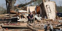 ROLLING FORK, MISSISSIPPI - MARCH 28: A women sits among the rubble of a home as cleanup continues in the aftermath of Friday's tornado on March 28, 2023 in Rolling Fork, Mississippi. At least 26 people died when an EF-4 tornado ripped through the small town and nearby Rolling Fork on Friday evening. (Photo by Scott Olson/Getty Images)