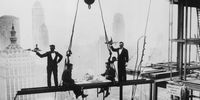 Two waiters serve two steel workers lunch, on a girder high above New York City, 14th November 1930. The building upon which they are perched is the Waldorf-Astoria Hotel on Park Avenue, under construction by Thompson-Starrett. The building in the bottom left is the New York Central Building, later the Helmsley Building. (Photo by Keystone/Getty Images)
