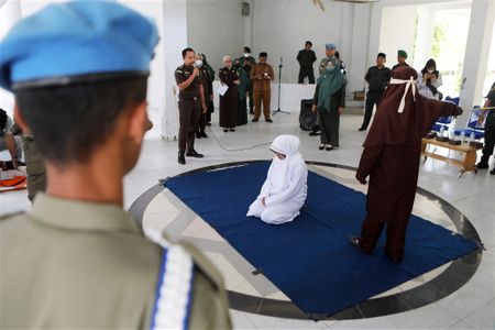 In images: EFF's protests; an Acehnese woman receives caning punishment in Indonesia