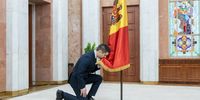 Newly-appointed Minister of Foreign Affairs and European Integration of Republic of Moldova Mihai Popsoi kisses the national flag during swearing-in ceremony in Presidential building in Chisinau, Moldova, 29 January 2024.  EPA-EFE/DUMITRU DORU