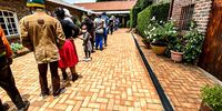 Patience Tele with her father, January, in the St Francis Christmas lunch queue, Parkview, Johannesburg. (Photo: Angus Begg)