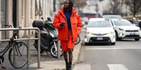 A guest wears a blue turtleneck pullover, an orange bomber jacket, orange shorts, brown boots, socks, outside K-WAY, during the Milan Fashion Week - Menswear Fall/Winter 2024-2025 on January 14, 2024 in Milan, Italy. (Photo by Edward Berthelot/Getty Images)