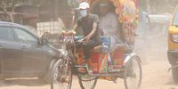 A rickshaw puller covers his mouth and nose with a facemask as he rides in an area clouded in dust and smoke, in Rayer Bazaar area of Dhaka, Bangladesh, 24 April 2024. Dhaka continues to be ranked as one of the world's most polluted cities, with debris from construction, industrial pollution, vehicle emissions and brick kilns listed as major contributors to air pollution in the city.  EPA-EFE/MONIRUL ALAM
