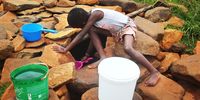 The girl draws water from an unprotected well in Ha Ino. (Photo: Sechaba Mokhethi)