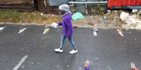  A South African child marks her place in a line for food from the Masiphumelele Creative Hub feeding scheme run by Yandiswa Mazwana in Masiphumelele, Cape Town, South Africa 28 May 2020.  The Western Cape of South Africa is the worst hit province with the coronavirus SARS-CoV-2 which causes the Covid-19 disease. South Africa is following a government risk adjusted strategy with a phased easing of lockdown. The country has some of the most severe lockdown rules in the world with an observed low level of compliance in the high density informal settlements across the country. (Photo: EPA-EFE/NIC BOTHMA)