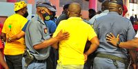 Police apprehend an ANC supporter carrying a firearm at the venue of a parliamentary sitting. (Photo: Lucas Ledwaba)