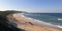 Looking north along the beach from Ponta Membene, with e-bikes at the ready. (Photo: Keith Bain)