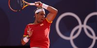 PARIS, FRANCE - JULY 28: Rafael Nadal of Team Spain plays a forehand against Marton Fucsovics of Team Hungary during the Men’s Singles first round match on day two of the Olympic Games Paris 2024 at Roland Garros on July 28, 2024 in Paris, France. (Photo by Clive Brunskill/Getty Images)