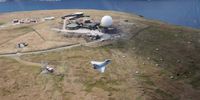 An RAF Typhoon jet flies over an air defence radar at Saxa Vord. (Photo: RAF)