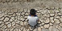A Thai villager boy sits on drought parched land at a dried up irrigation canal in Chachoengsao province, Thailand, 05 March 2016. Thailand is facing the worst drought in decades caused by climate change and a renewed El Nino combined with seasonal hot weather, affecting the country's rice paddy fields and its crop production after the military junta told farmers to cultivate less rice and urged public using water sparingly as part of the water saving measure campaign.  EPA/RUNGROJ YONGRIT