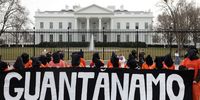 WASHINGTON, DC - JANUARY 11:  Activists in orange jumpsuits, representing the 35 men who are still being held at the U.S. detention facility in Guantanamo Bay, Cuba, participate in a protest in front of the White House on January 11, 2023 at Lafayette Square in Washington, DC. Activists staged a demonstration to mark the 21 years since the first prisoners were brought to Guantanamo Bay and to demand that President Joe Biden close the facility and end indefinite military detention. (Photo by Alex Wong/Getty Images)
