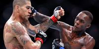  Israel Adesanya (R) of Nigeria punches Alex Pereira of Brazil in their middleweight title bout during UFC 287 at Kaseya Center on April 08, 2023 in Miami, Florida. (Photo by Carmen Mandato/Getty Images)