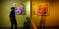 A woman looks at the 'Marilyn Monroe' series during the inauguration of the Andy Warhol Pop Art exhibit at the RCB Galleria in Bangkok, Thailand, 11 August 2020. Image: EPA-EFE/DIEGO AZUBEL