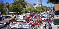 Activists from Cape Town housing rights group Reclaim the City march in support of releasing the Tafelberg site in Sea Point for social housing development on 8 February 2024. (Photo: Supplied/Ndifuna Ukwazi)