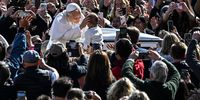 Pope Leo XIV blesses a child while greeting cheering crowds from his popemobile, and more from around the world