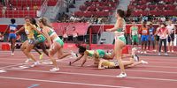 TOKYO, JAPAN - JULY 31: Runners stumble during the baton handoff in the 4 x 400m Relay Mixed Final on day eight of the Tokyo 2020 Olympic Games at Olympic Stadium on July 31, 2021 in Tokyo, Japan. (Photo by Patrick Smith/Getty Images)
