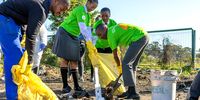 Students roll up their sleeves and take action by cleaning up their local environment, demonstrating their commitment to building a cleaner, healthier South Africa. (Photo: Laura Klapper)