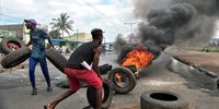 Demonstrators place tyres on a burning barricade during a post-election protest in Maputo, Mozambique, on 6 December 2024. (Photo: EPA-EFE / Luisa Nhantumbo)