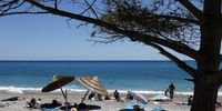 People enjoy the sun on a beach in Antibes, France, 07 August 2023. Temperatures reached up to 28 Celcius degrees in Nice.  EPA-EFE/SEBASTIEN NOGIER