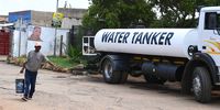 Elvis Nkuna fetches water from a community water tank  in Mamelodi, Pretoria, on 7 February 2024. (Photo: Gallo Images / Lefty Shivambu)