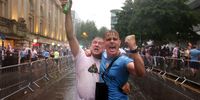 Manchester City fans celebrate in the rain during the Manchester City trophy parade on June 12, 2023 in Manchester, England. (Photo by George Wood/Getty Images)
