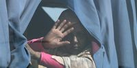 A Sudanese woman waves from a bus on a Nile ferry after crossing the border from Sudan, Abu Simbel, southern Egypt, 17 May 2023. According to the UNHCR office, 83,758 Sudanese have crossed into Egypt since the beginning of an armed conflict on 15 April between the Sudanese military and the RSF (Rapid Support Forces) militia. The UN estimates some 200,000 people have fled Sudan since the conflict erupted.  EPA-EFE/KHALED ELFIQI