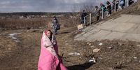 IRPIN, UKRAINE - MARCH 10: An elderly woman waits for assistance as she evacuates Irpin via a destroyed bridge <br>on March 10, 2022 in Irpin, Ukraine. Irpin, a suburb northwest of Kyiv, had experienced days of sustained shelling by Russian forces advancing toward the capital. Well over two million people have fled Ukraine since Russia launched its attack on February 24. (Photo by Chris McGrath/Getty Images)