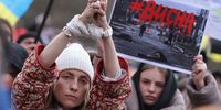 BERLIN, GERMANY - APRIL 06: A protester holds up her hands symbolically bound in reference to the bound and murdered civilians of the Ukrainian town of Bucha near Kyiv during a demonstration against the Russian military invasion of Ukraine on April 06, 2022 in Berlin, Germany. Protest leaders called for a full embargo against Russia and an end to civilian deaths in the war. Meanwhile the numbers of confirmed civilian dead in towns north of Kyiv like Bucha, Irpin and Hostomel are continuing to rise in the wake of the Russian military retreat following their occupation of the area. (Photo by Sean Gallup/Getty Images)