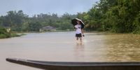 A man walks through a flood area in Kuala Terengganu, Malaysia, 21 December 2022. According to Malaysian authorities, five people were killed and more than 70,000 were evacuated after monsoons triggered floods that inundated the state of Kelantan, Terengganu and Pahang.  EPA-EFE/STR