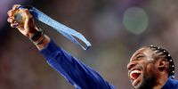 Noah Lyles of the USA celebrates with his gold medal during the medal ceremony for the Men 100m final of the Athletics competitions in the Paris 2024 Olympic Games, at the Stade de France stadium in Saint Denis, France, 05 August 2024.  EPA-EFE/ANNA SZILAGYI