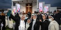 ERBIL, IRAQ - MARCH 07: Nuns take a selfie after the completion of a mass conducted by Pope Francis at the Franso Hariri Stadium on March 07, 2021 in Erbil, Iraq. Pope Francis arrived in Erbil, the final stop of his historic four-day visit, the first ever papal visit to Iraq. In his first foreign trip since the start of the pandemic Pope Francis visited Baghdad, Najaf, Erbil and the cities of Qaraqosh and Mosul, which were heavily destroyed by ISIS. Although the trip is seen as an act of solidarity, the Vatican has been forced to defend the decision to go ahead with the papal visit amid the ongoing coronavirus pandemic, as Iraq is currently seeing a spike in infection rates as it faces a deadly second wave of the virus. (Photo by Chris McGrath/Getty Images)
