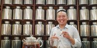 Mingwei Tsai in front of a small section of his ‘library’ of 580 teas and blends at Nigiro Teacafe. (Photo: Patrick Heathcock)<br>
