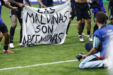 Argentine players brandish political Falklands flag after England match
