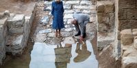 AMMAN, JORDAN - NOVEMBER 16: Britain's Prince Charles, Prince of Wales, touches the water next to Camilla, Duchess of Cornwall, during a visit to the baptism site along the Jordan River,  on November 16, 2021 in Amman, Jordan. Prince Charles will next head to Egypt during his four-day trip to the region. (Photo by Peter Nicholls - Pool/Getty Images)