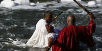 Bishops of the Morian Africa Church in Katlehong hit the water with sticks to evoke the spirit during the baptism. Photo: Felix Dlangamandla 