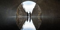 TOKAMACHI, JAPAN - NOVEMBER 21: Visitors pose for a photograph on a viewing platform with the artwork “Tunnel of Light” (Echigo-Tsumari Art Field) by Ma Yansong / MAD Architects at the Kiyotsu-kyo Gorge on November 21, 2021 in Tokamachi, Japan. (Photo by Tomohiro Ohsumi/Getty Images)