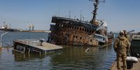 epa09917500 A picture taken during a visit to Mariupol organized by the Russian military shows Russian servicemen stand in front of the sunken control ship 'Donbass' of the Ukrainian Navy in the territory of the cargo sea port in Mariupol, Ukraine, 29 April 2022. Mariupol is located on the northern coast of the Sea of Azov, it is one of the largest commercial seaports in Ukraine. Almost 500 thousand people previously lived in the city. On 16 April, the Russian Defense Ministry announced that the urban area of Mariupol had been cleared of the Ukrainian military, and their remnants were completely blocked on the territory of the Azovstal metallurgical plant. On 24 February Russian troops had entered Ukrainian territory in what the Russian president declared a 'special military operation', resulting in fighting and destruction in the country, a huge flow of refugees, and multiple sanctions against Russia.  EPA-EFE/SERGEI ILNITSKY