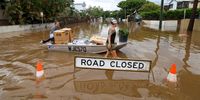 BRISBANE, AUSTRALIA - MARCH 03: People use a boat to save items from their home at Torwood Street, Auchenflower on March 03, 2022 in Brisbane, Australia. From Brisbane in Queensland to Lismore in northern New South Wales, flood-affected communities are cleaning up debris as the weather system moves south towards Sydney. (Photo by Peter Wallis/Getty Images)